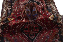 Corner detail of 2000s Shiraz rug showing border pattern and Wool pile