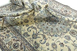 Surface texture of 2000s Nain rug with natural Wool and intricate pattern