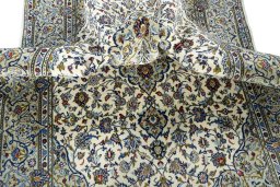 Backside of handmade 2000s Kashan rug showing knot structure and weave density