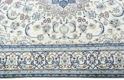 Corner detail of 2000s Nain rug showing border pattern and Wool pile