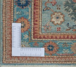 Corner detail of New Kazak rug showing border pattern and Wool pile