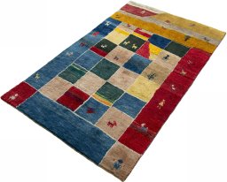 Corner detail of 2000s Persian Gabbeh rug showing border pattern and Wool pile