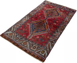 Corner detail of 2000s Shiraz rug showing border pattern and Wool pile