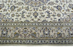 Corner detail of 2000s Kashan rug showing border pattern and Wool pile