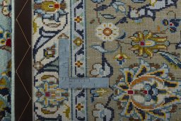 Backside of handmade 2000s Kashan rug showing knot structure and weave density