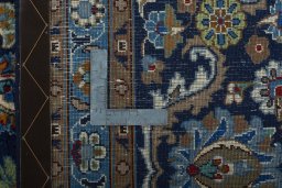 Backside of handmade 2000s Kashmar rug showing knot structure and weave density