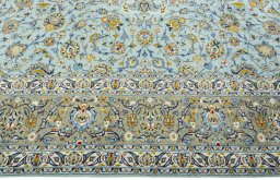 Corner detail of 2000s Kashan rug showing border pattern and Wool pile