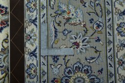Backside of handmade New Kashan rug showing knot structure and weave density