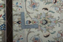 Backside of handmade New Kashan rug showing knot structure and weave density