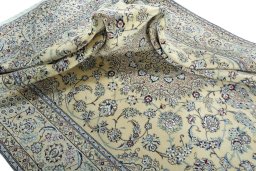 Surface texture of 2000s Nain rug with natural Wool and intricate pattern