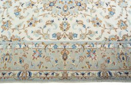 Corner detail of New Kashan rug showing border pattern and Wool pile