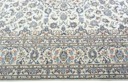 Corner detail of 2000s Kashan rug showing border pattern and Wool pile