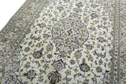 Backside of handmade 2000s Kashan rug showing knot structure and weave density