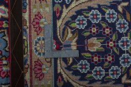 Backside of handmade 1970s Kerman rug showing knot structure and weave density