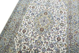 Backside of handmade 2000s Kashan rug showing knot structure and weave density