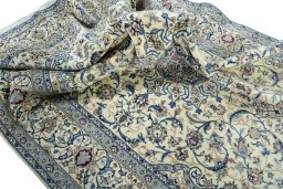 Surface texture of 2000s Nain rug with natural Wool and intricate pattern