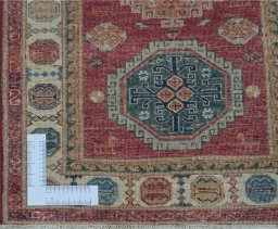 Corner detail of New Kazak rug showing border pattern and Wool pile