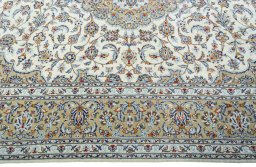 Corner detail of 2000s Kashan rug showing border pattern and Wool pile