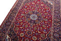 Backside of handmade 2000s Kashan rug showing knot structure and weave density