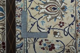 Backside of handmade New Nain rug showing knot structure and weave density