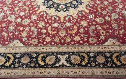 Corner detail of 2000s Tabriz 50/60/70 Raj rug showing border pattern and Cork pile