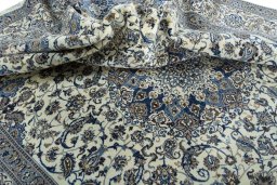 Surface texture of 2000s Nain rug with natural Wool and intricate pattern