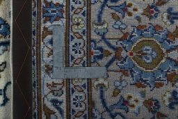 Backside of handmade 2000s Kashan rug showing knot structure and weave density