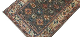 Backside of handmade New Kazak rug showing knot structure and weave density