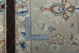Backside of handmade New Kashan rug showing knot structure and weave density