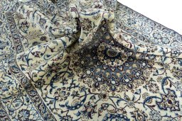 Surface texture of 2000s Nain rug with natural Wool and intricate pattern