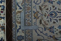 Backside of handmade 2000s Kashan rug showing knot structure and weave density
