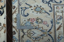 Backside of handmade New Kashan rug showing knot structure and weave density