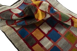 Corner detail of 2000s Persian Gabbeh rug showing border pattern and Wool pile