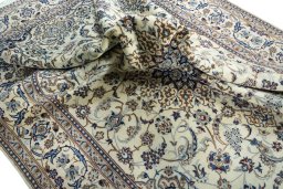Surface texture of 2000s Nain rug with natural Wool and intricate pattern