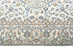 Corner detail of 2000s Kashan rug showing border pattern and Wool pile
