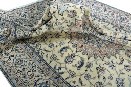 Surface texture of 2000s Nain rug with natural Wool and intricate pattern