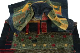 Corner detail of 2000s Persian Gabbeh rug showing border pattern and Wool pile