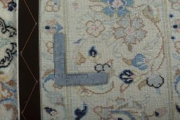 Backside of handmade New Kashan rug showing knot structure and weave density