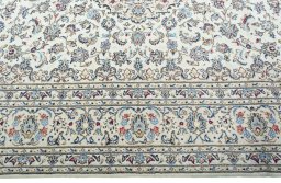 Corner detail of 2000s Kashan rug showing border pattern and Wool pile