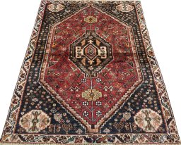 Surface texture of 2000s Shiraz rug with natural Wool and intricate pattern