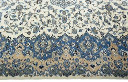 Corner detail of 2000s Kashan rug showing border pattern and Wool pile