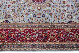 Corner detail of 2000s Kashan rug showing border pattern and Wool pile