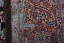 Backside of handmade 2000s Kashan rug showing knot structure and weave density