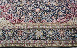 Corner detail of 1970s Kerman rug showing border pattern and Wool pile