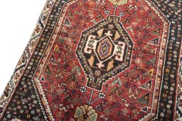 Backside of handmade 2000s Shiraz rug showing knot structure and weave density