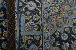 Backside of handmade 2000s Kashan rug showing knot structure and weave density
