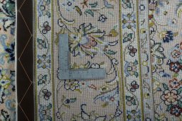 Backside of handmade New Kashan rug showing knot structure and weave density