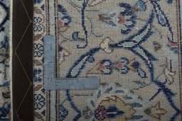 Backside of handmade 2000s Kashan rug showing knot structure and weave density