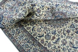 Surface texture of 2000s Nain rug with natural Wool and intricate pattern