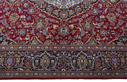 Corner detail of 2000s Kashan rug showing border pattern and Cork pile